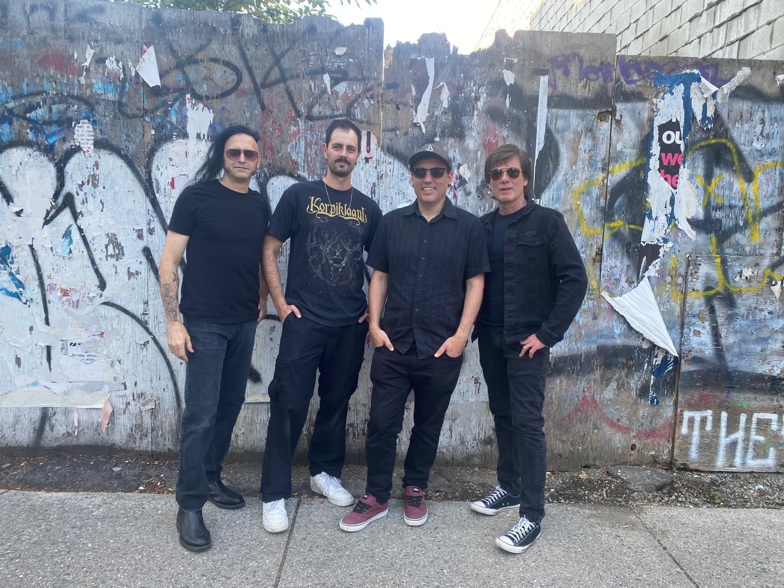 Granite band press photo — the four-piece Vancouver metal and grunge band standing against a graffitied wall